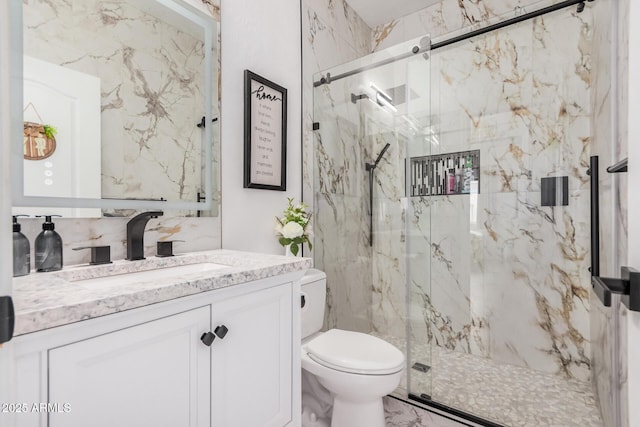 bathroom featuring a marble finish shower, marble finish floor, toilet, and vanity