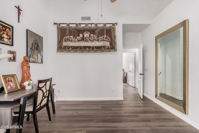 dining room with ceiling fan, visible vents, baseboards, and dark wood-style floors