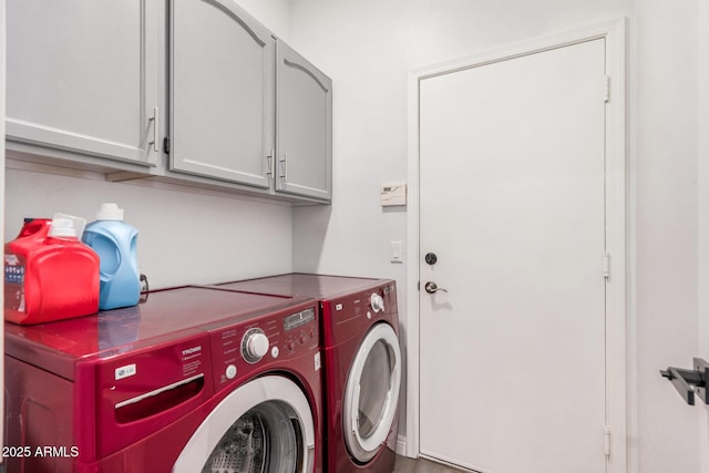 clothes washing area with cabinet space and washer and clothes dryer