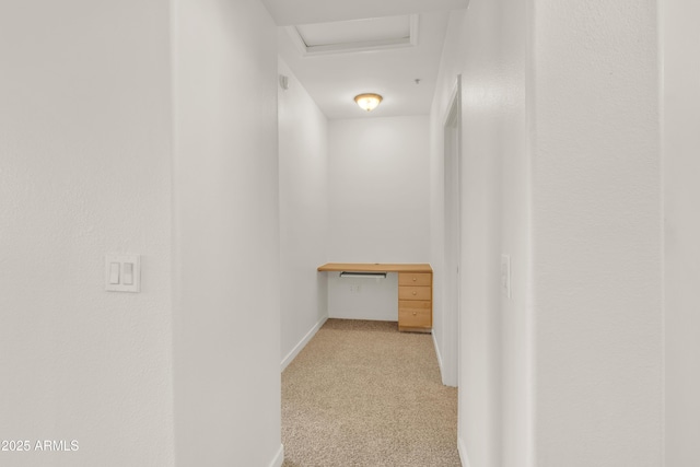 hallway with light colored carpet