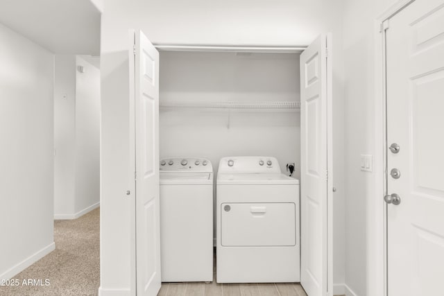 washroom featuring washing machine and clothes dryer