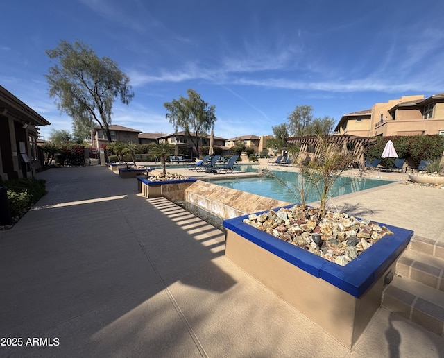 view of pool with a patio and a pergola