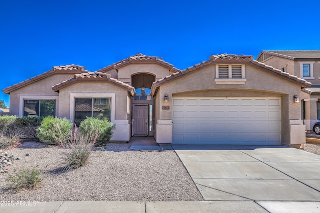 17617 W Corrine Dr, Surprise, AZ 85388 - mediterranean / spanish house with a garage, stucco siding, concrete driveway, and a tiled roof