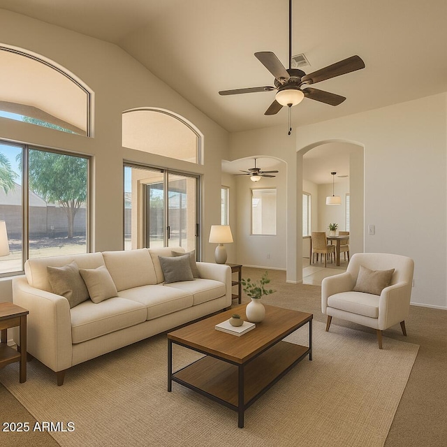 17617 W Corrine Dr, Surprise, AZ 85388 - living area with arched walkways, a ceiling fan, lofted ceiling, and light carpet
