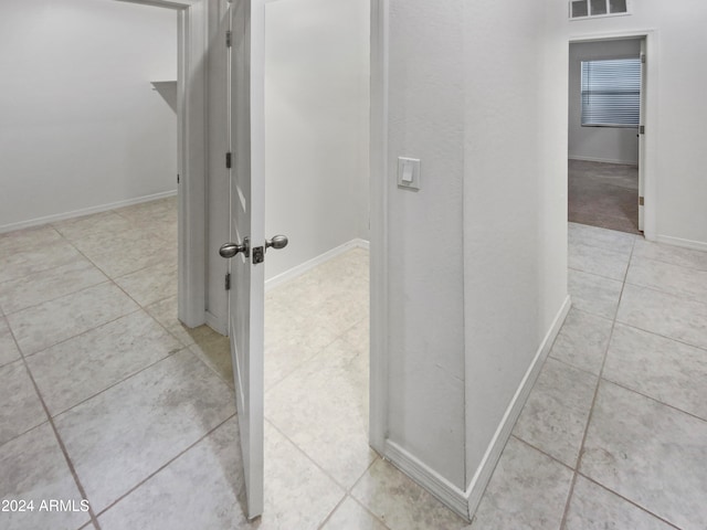 corridor with light tile patterned floors