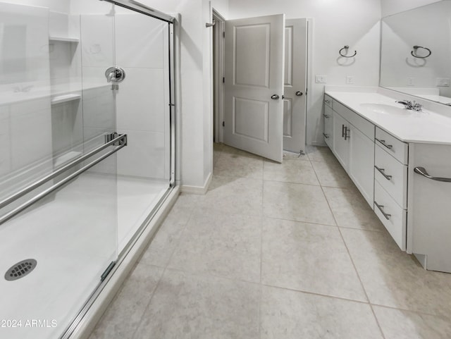 bathroom with tile patterned flooring, vanity, and an enclosed shower