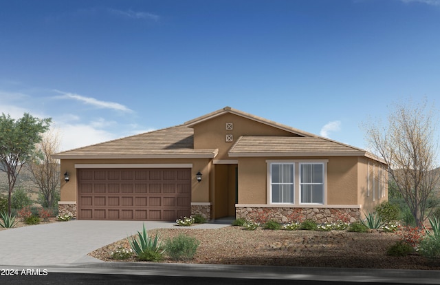 view of front of property with driveway, stone siding, an attached garage, and stucco siding