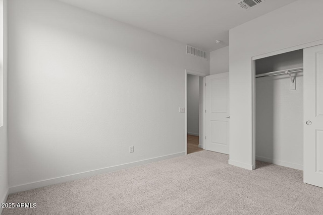 unfurnished bedroom with a closet, baseboards, visible vents, and carpet flooring