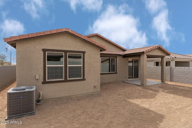 back of property featuring a patio area, a fenced backyard, central AC, and stucco siding