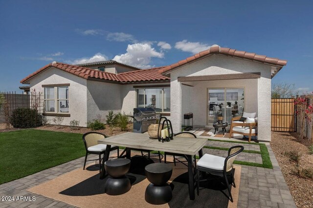 back of property featuring a patio, outdoor dining area, fence, and stucco siding