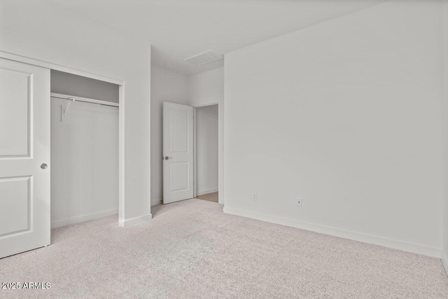 unfurnished bedroom with a closet, baseboards, and carpet flooring