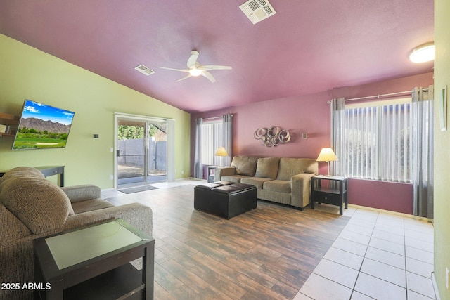 living room with hardwood / wood-style floors, vaulted ceiling, and ceiling fan