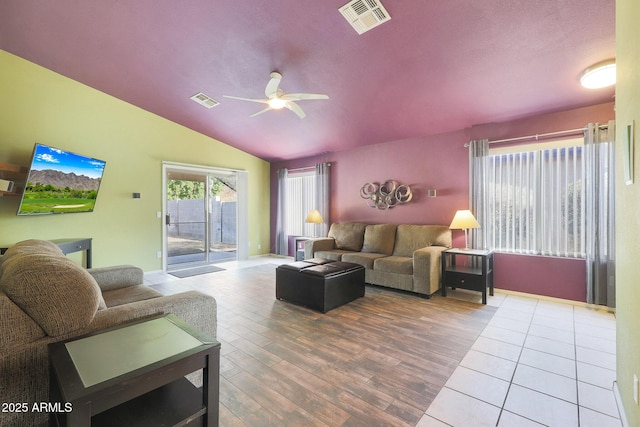 living room featuring ceiling fan, wood-type flooring, and vaulted ceiling