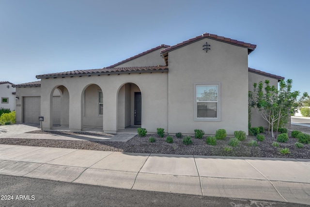 mediterranean / spanish-style house with a garage