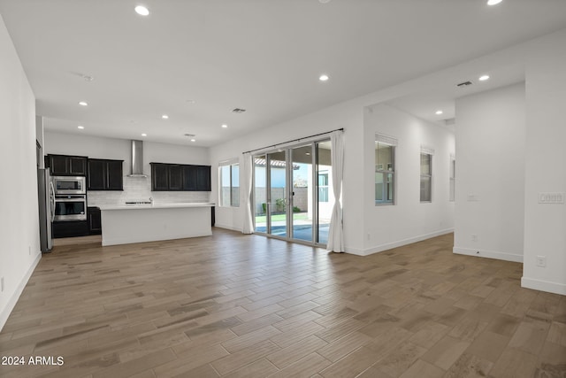 unfurnished living room with light hardwood / wood-style flooring