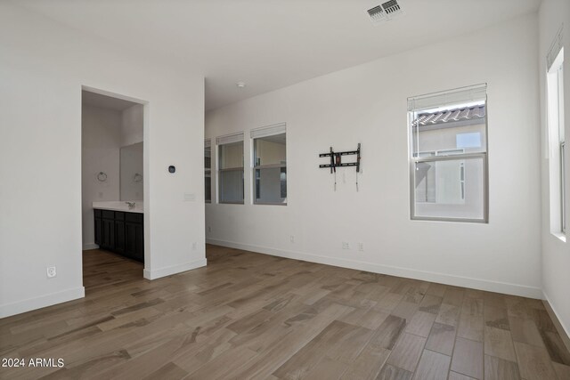 spare room featuring ceiling fan and light hardwood / wood-style flooring