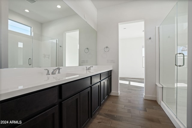 bathroom featuring walk in shower, vanity, and hardwood / wood-style flooring