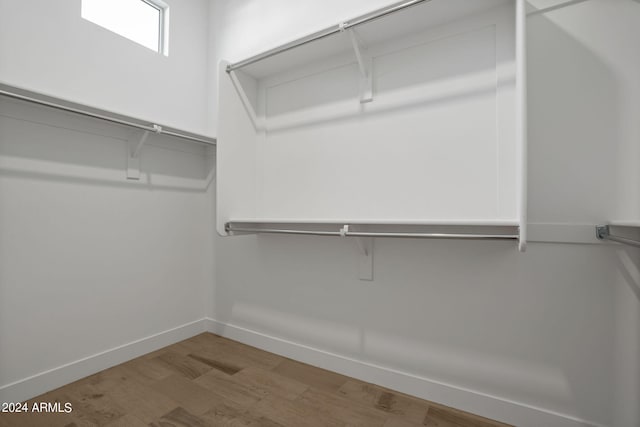 spacious closet with hardwood / wood-style floors