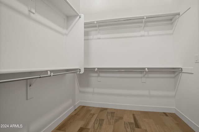 walk in closet featuring hardwood / wood-style floors