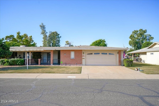 single story home featuring a garage and a front lawn