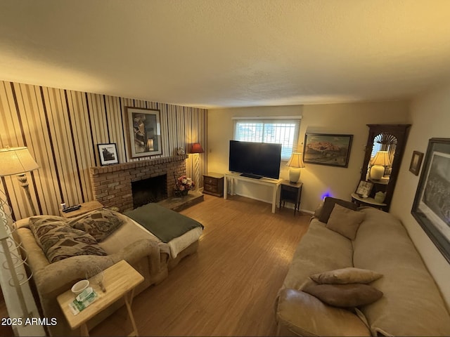 living area featuring a brick fireplace and wood finished floors