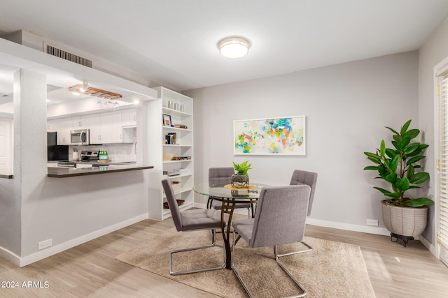 dining area featuring light wood-type flooring