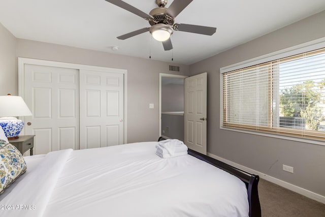 carpeted bedroom featuring a closet and ceiling fan