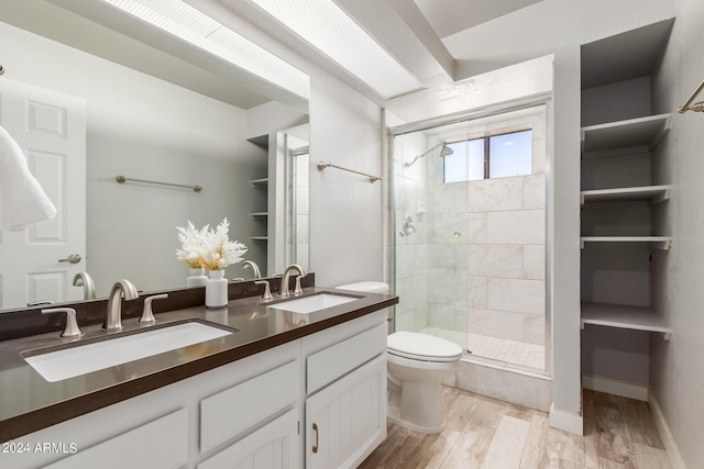 bathroom featuring hardwood / wood-style floors, vanity, toilet, and an enclosed shower