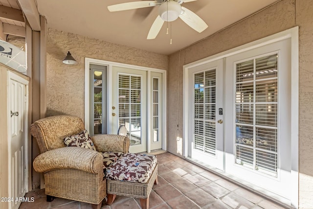 sunroom / solarium featuring ceiling fan