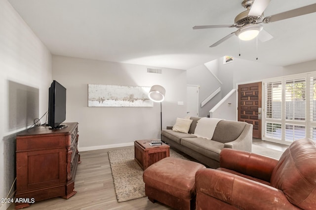 living room with ceiling fan and light hardwood / wood-style flooring