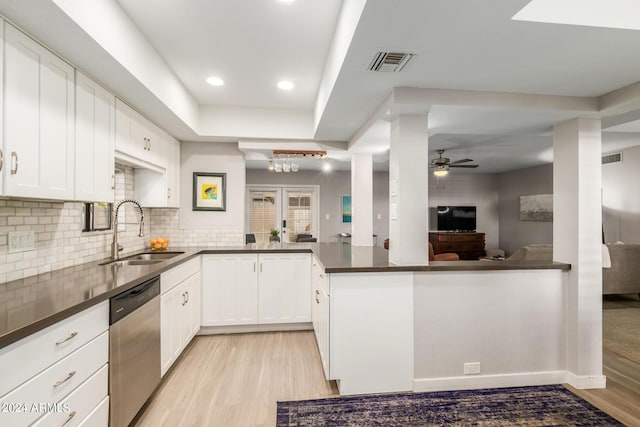 dining area with a tray ceiling and wood-type flooring