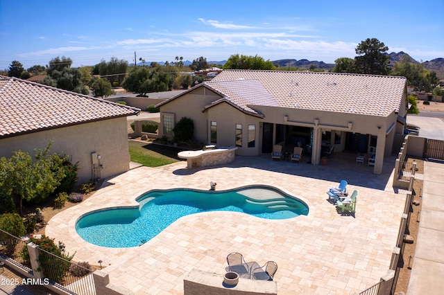 view of pool with a fenced in pool, a patio, a mountain view, and fence