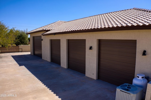 garage with central AC and fence