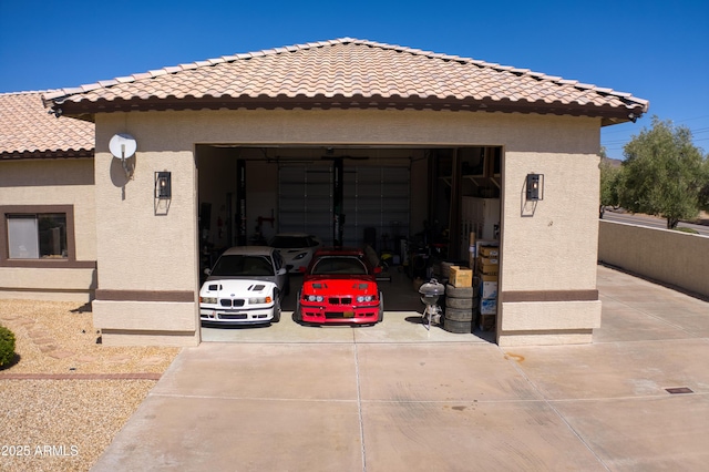 garage featuring concrete driveway