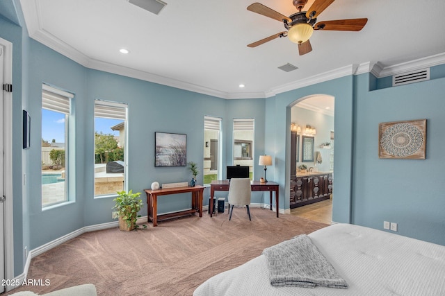 bedroom with baseboards, arched walkways, carpet floors, and visible vents