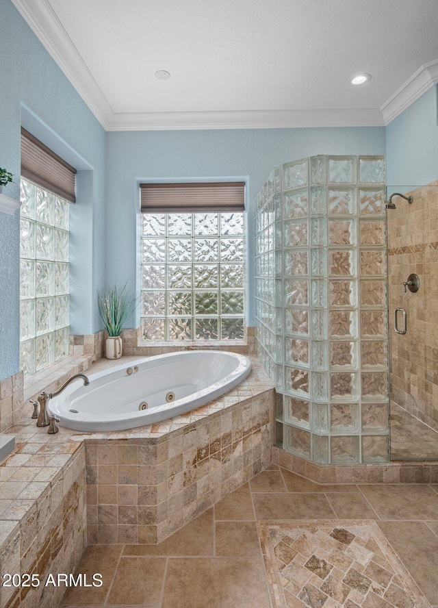 bathroom featuring stone finish floor, ornamental molding, a whirlpool tub, and a tile shower