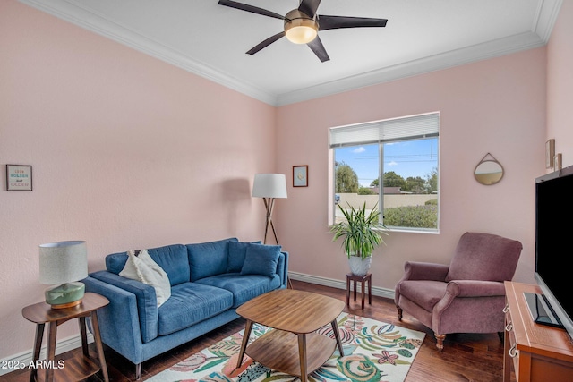 living area with baseboards, dark wood-style flooring, a ceiling fan, and crown molding