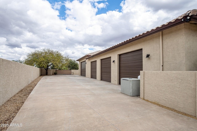 garage with central air condition unit and fence