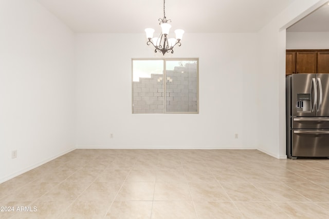 unfurnished dining area featuring light tile patterned flooring and an inviting chandelier