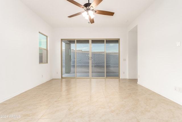 tiled empty room with ceiling fan