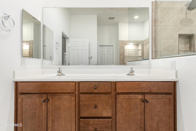 bathroom with walk in shower and vanity