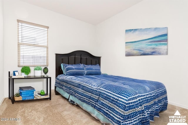 bedroom featuring carpet floors and vaulted ceiling