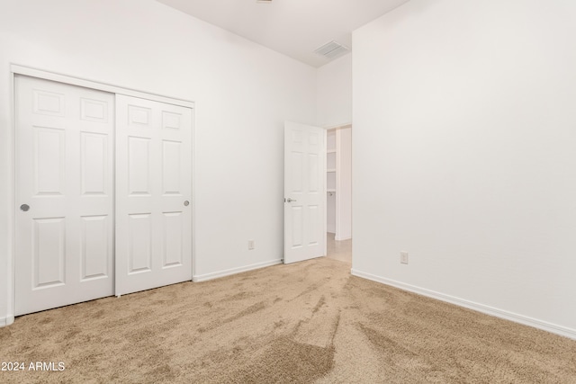 unfurnished bedroom featuring carpet floors and a closet