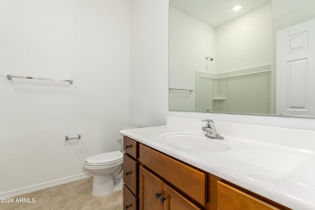 bathroom featuring vanity, tile patterned flooring, and toilet