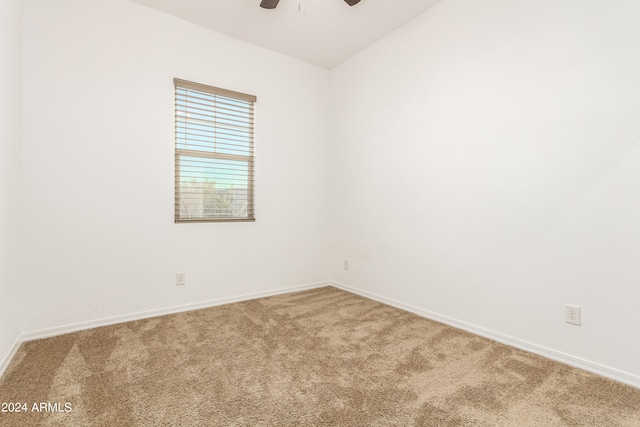 carpeted spare room with ceiling fan