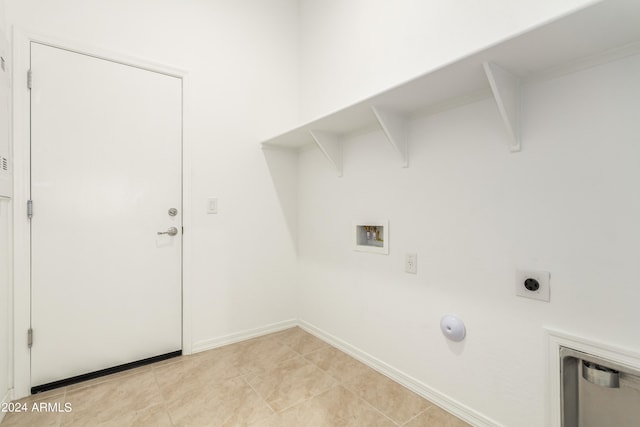 washroom featuring hookup for a washing machine and light tile patterned flooring