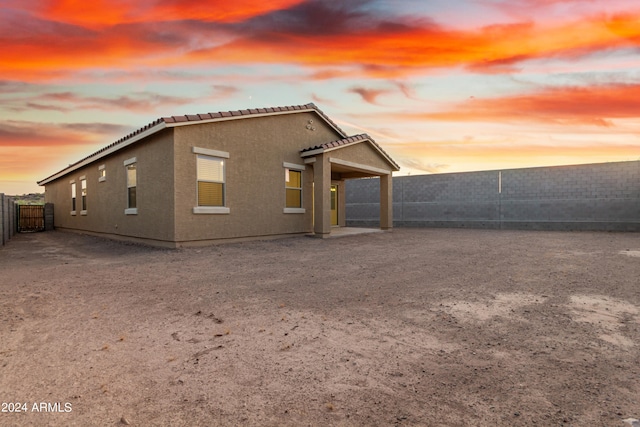 view of back house at dusk