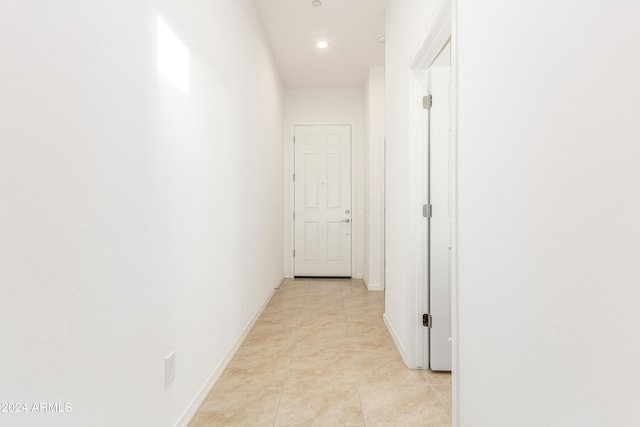 hall featuring light tile patterned floors