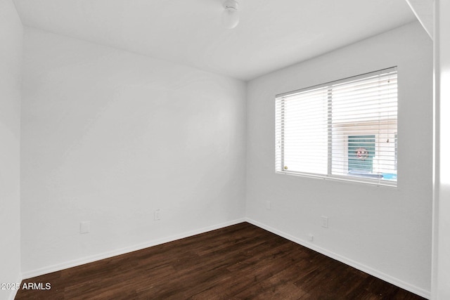 empty room featuring dark hardwood / wood-style flooring