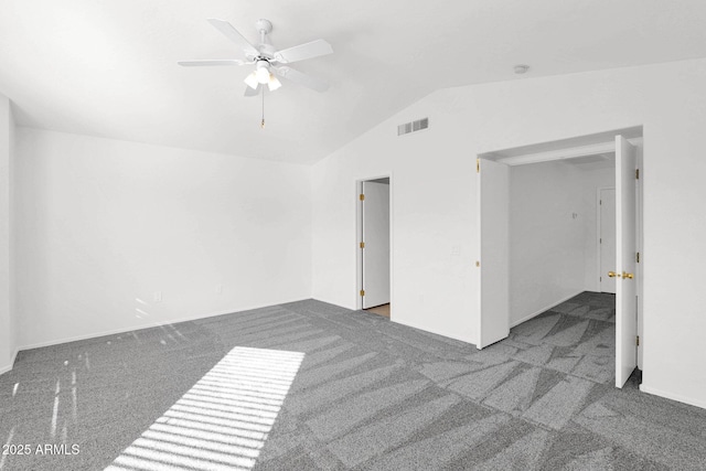 unfurnished room featuring lofted ceiling, ceiling fan, and dark colored carpet